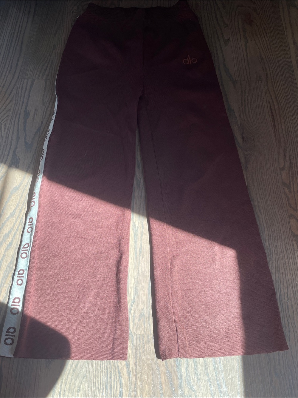 ALO Yoga Maroon Wide-Leg Joggers with White Logo Side Tape you will get both
